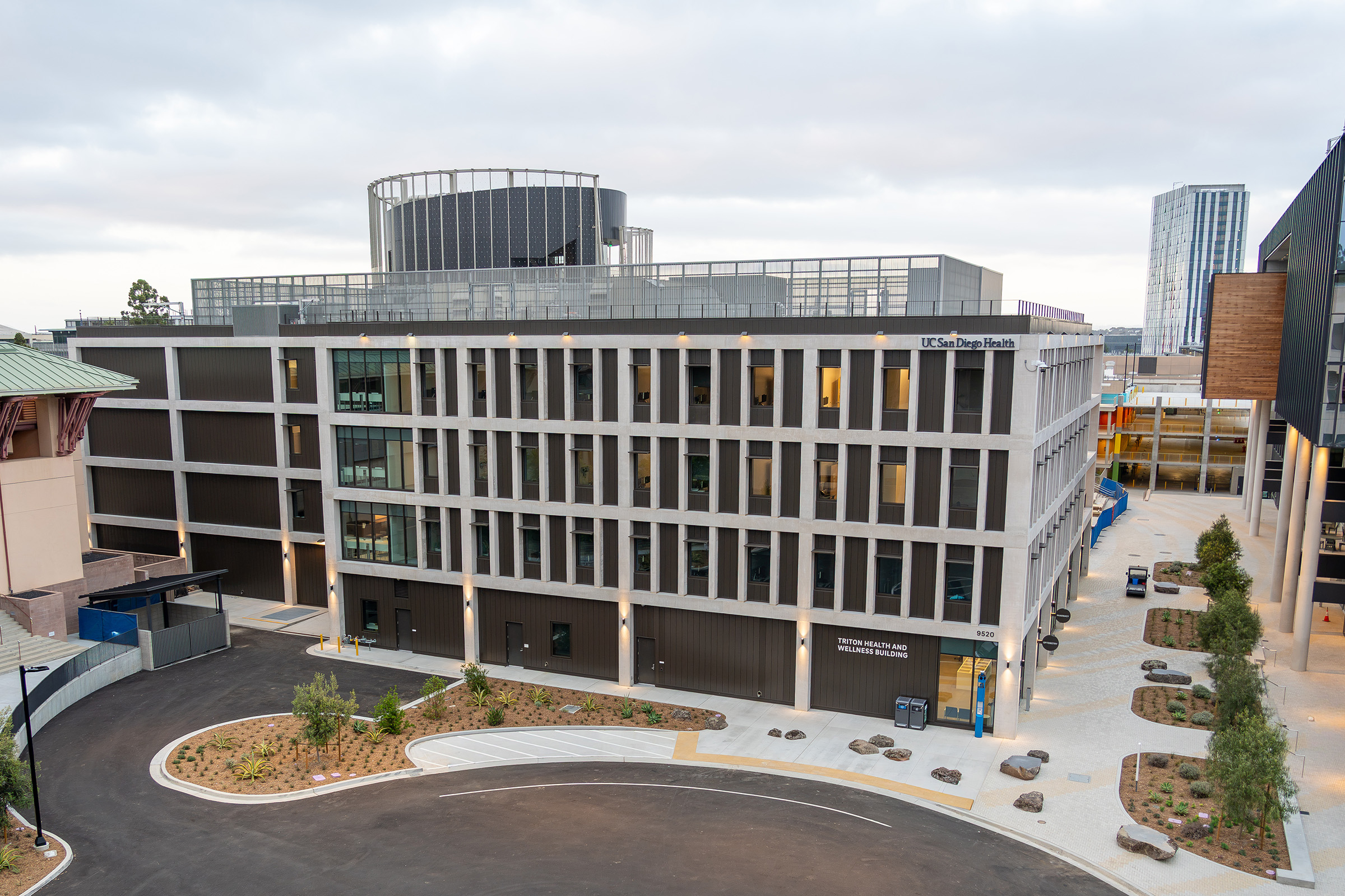 Exterior of large gray and brown building with signage that reads: Triton Health and Wellness Building.