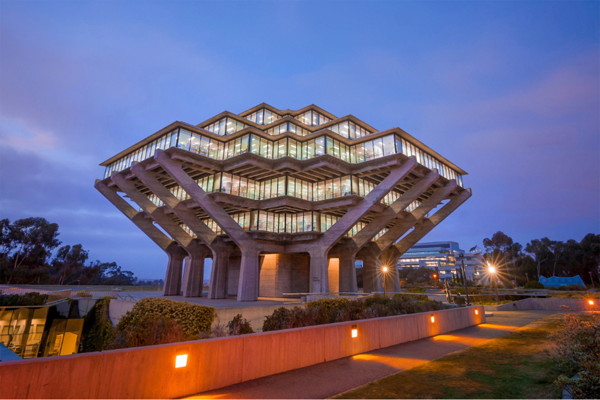 Geisel Library lit up against blue evening sky